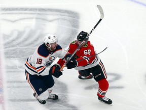 James Neal (No. 18) of the Edmonton Oilers and Slater Koekkoek (No. 68) of the Chicago Blackhawks get tied up during the first period in Game 3 of the Western Conference Qualification Round prior to the 2020 NHL Stanley Cup Playoffs at Rogers Place on August 05, 2020.
