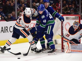 Edmonton Oilers defenceman Ethan Bear (74) works against Vancouver Canucks forward Elias Pettersson (40) at Rogers Arena on Dec. 1, 2019.