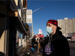 ?!WHY NOT¡¿ cafe and bar co-owner Levi Biddlecombe speaks to the media as Edmonton Fire Rescue Services firefighters investigate a morning fire at ?!WHY NOT¡¿ cafe and bar above the bike shop at 8534 109 Street in Edmonton, on Sunday, Dec. 6, 2020.