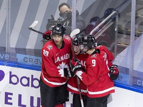 Canada's Jakob Pelletier (12) celebrates his goal with teammates Quinton Byfield (19) and Connor Zary (9) against Switzerland during second period IIHF World Junior Hockey Championship action on Tuesday, Dec. 29, 2020, in Edmonton.