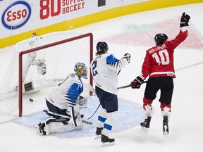 Canada's Dylan Holloway (10) celebrates a goal as  Finland's goalie Kari Piiroinen (1) and Santeri Hatakka (2) watch during second period IIHF World Junior Hockey Championship action on Thursday, Dec. 31, 2020 in Edmonton.