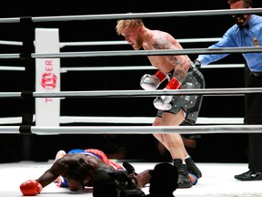 Jake Paul (grey trunks) knocks out Nate Robinson (red and blue trunks) during a cruiserweight boxing bout at Staples Center in Los Angeles on Nov. 28, 2020.