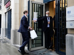 People are seen at the entrance of the UK Mission to the EU, in Brussels December 24, 2020.