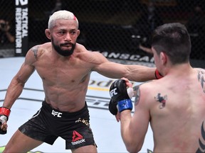 Deiveson Figueiredo, left, of Brazil punches Brandon Moreno of Mexico in their flyweight championship bout during the UFC 256 event at UFC APEX on Dec. 12, 2020 in Las Vegas, Nev.