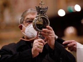 Archbishop Cardinal Crescenzio Sepe holds a vial containing the blood of San Gennaro in Naples, Italy, December 16, 2020.