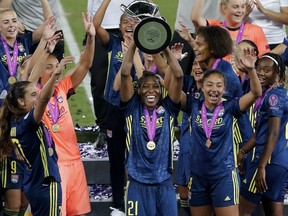 Olympique Lyonnais defender Kadeisha Buchanan celebrates with the trophy after winning the Champions League, Final on Sunday, Aug. 30, 2020.