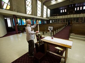 Rev. Geoffrey Wilfong-Pritchard uses his phone to film part of his weekly sermon in an empty St. Andrew's United Church on April 30, 2020. Due to the COVID-19 pandemic Wilfong-Pritchard films his weekly sermon and then edits a video Sunday service for his parishioners. The sermons are available to parishioners on Youtube.