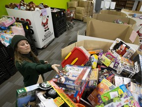 Santas Anonymous staff member Gianna Vacirca sorts toys at the Santas Anonymous depot on Dec. 12, 2018. The charity is gearing up for its big delivery weekend and 1,500 volunteer delivery drivers were needed to deliver presents to 10,000 households.