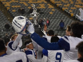 The Harry Ainlay Titans hoist the Metro championship trophy at Commonwealth Stadium on Nov. 8, 2019.