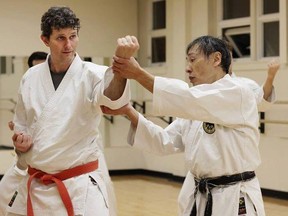 Doug Aoki, right, instructs student Matt Unger at the Nantanreikan Seibukan Karate Dojo in Edmonton prior to the COVID-19 pandemic.