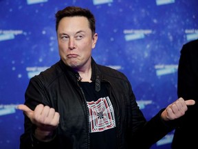 SpaceX owner and Tesla CEO Elon Musk grimaces after arriving on the red carpet for the Axel Springer award, in Berlin, Germany, December 1, 2020.