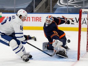 Goaltender Mikko Koskinen #19 of the Edmonton Oilers makes a save against Mitchell Marner #16 of the Toronto Maple Leafs at Rogers Place on January 28, 2021 in Edmonton, Canada.