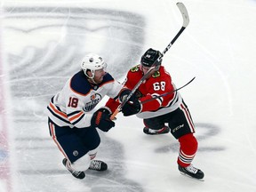 EDMONTON, ALBERTA - AUGUST 05:  James Neal #18 of the Edmonton Oilers and Slater Koekkoek #68 of the Chicago Blackhawks get tied up during the first period in Game Three of the Western Conference Qualification Round prior to the 2020 NHL Stanley Cup Playoffs at Rogers Place on August 05, 2020 in Edmonton, Alberta. (Photo by Jeff Vinnick/Getty Images)
