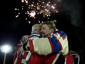 Brent Saik (right) hugs James McCormack as the World's Longest Hockey Game comes to a close near Sherwood Park in this file photo from Feb. 19, 2018.