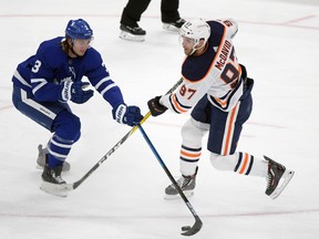 Toronto Maple Leafs defenceman Justin Holl (3) steals the puck away from Edmonton Oilers forward Connor McDavid (97) in the second period at Scotiabank Arena on Jan. 20, 2021.