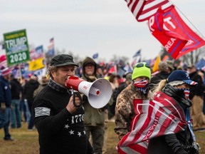 A man calls for the storming of the U.S. Capitol building in Washington, D.C. on January 6, 2021, as a total of six buses and about 300 people followed by AFP, took part in the Supper Fun Happy America journey to Washington, D.C. from Boston to take part in the protest and rallies in the district.