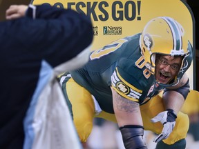 John Wheeler hams it up for a photo at the Edmonton Football Team's annual Locker-Room Sale at Commonwealth Stadium in this file photo from Dec. 12, 2015.