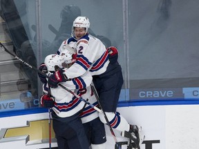 United States' Alex Turcotte (15) celebrates his goal on Canada with teammates Trevor Zegras (9) and Drew Helleson (2) during first period IIHF World Junior Hockey Championship gold medal action on Tuesday, Jan. 5, 2021 in Edmonton.