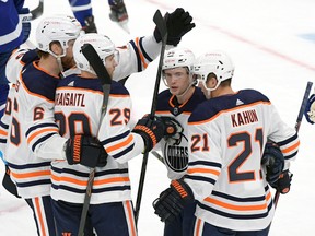 Edmonton Oilers forward Kailer Yamamoto (56) celebrates with teammates after scoring against the Toronto Maple Leafs at Scotiabank Arena on Wednesday, Jan. 20, 2021.