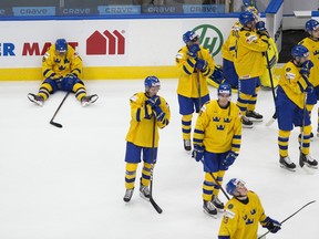 Dejected members of Team Sweden show their disappointment after losing to Finland, 3-2, in the quarter-final round of the IIHF world junior championships on Saturday, Jan. 2, 2021.