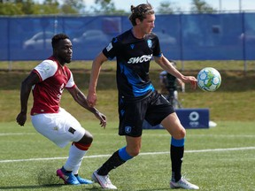 FC Edmonton striker Easton Ongaro, right, holds off Valour FC midfielder Raphael Ohin at the Canadian Premier League Island Games tournament in Charlottetown, P.E.I., on Aug. 29, 2020.