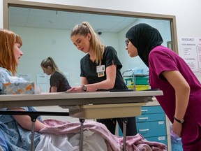 MacEwan University nursing students practice their skills with a standardized patient in the Clinical Simulation Centre.