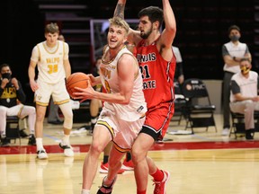 Valparaiso University forward Ben Krikke, of Edmonton, drives the lane against Illinois State forward Dusan Mahorcic on Sunday, Jan. 24, 2021, at Redbird Arena in Normal, Il.