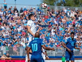 FC Edmonton Defender Amer Didic (55) jumps for a header against Halifax Wanderers FC Attacker Luis Perez (10) in this file photo from Sept. 28, 2019.