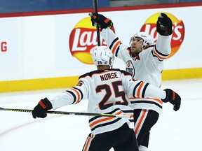 Edmonton Oilers centre Leon Draisaitl (right) celebrates his game-winning goal over the Winnipeg Jets in Winnipeg with defeceman Darnell Nurse on Sun., Jan. 24, 2021.