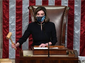 Speaker of the House Nancy Pelosi puts down the gravel as she presides the US House of Representatives vote on the impeachment of US President Donald Trump at the US Capitol, January 13, 2021, in Washington, DC. - The Democrat-controlled US House of Representatives on January 13 opened debate on a historic second impeachment of President Donald Trump over his supporters' attack of the Capitol that left five dead. (Photo by SAUL LOEB / AFP)