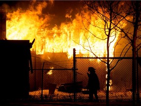 Fire crews battle a blaze near 71 Street and 72 Avenue, in Edmonton Monday Jan. 11, 2021.