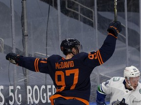 The Edmonton Oilers' Connor McDavid (97) celebrates the Oilers' second goal against the Vancouver Canucks during first period NHL action, in Edmonton Thursday Jan. 14, 2021.