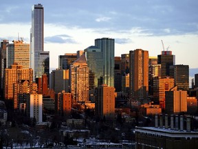 The rising sun illuminates the downtown Edmonton skyline on Thursday December 10, 2020.