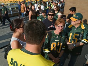 A volunteer sells 50-50 tickets at Commonwealth Stadium in Edmonton on July 14, 2017.