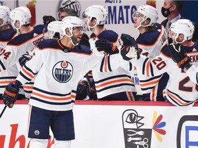Darnell Nurse #25 of the Edmonton Oilers celebrates his goal with teammates on the bench during the second period against the Montreal Canadiens at the Bell Centre on February 11, 2021 in Montreal, Canada.