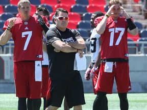 Offensive co-ordinator Jaime Elizondo is seen working with quarterback Trevor Harris (left) during Ottawa Redblacks practice in this file photo from June 26, 2017, at TD Place.