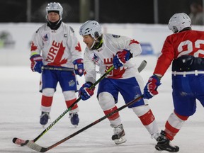 Team Cure’s Scott Bentley plays with the names of Super Moms on his jersey as hockey players raise funds in support of the Cure Cancer Foundation during the 2021 World’s Longest Hockey Game at Saiker's Acres near Sherwood Park on Thursday, Feb. 4, 2021.