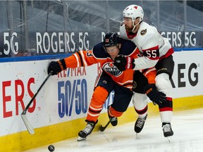 Edmonton Oilers' Jesse Puljujarvi (13) battles Ottawa Senators' Braydon Coburn (55) during first period NHL action at Rogers Place in Edmonton, on Tuesday, Feb. 2, 2021.