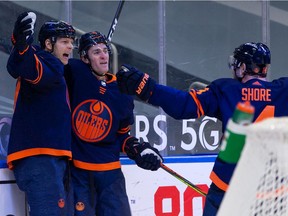 Edmonton Oilers' Alex Chiasson (39) celebrates a goal with Kyle Turris (8) and Devin Shore (14) on Winnipeg Jets' goaltender Connor Hellebuyck (37) during first period NHL action at Rogers Place in Edmonton, on Monday, Feb. 15, 2021.