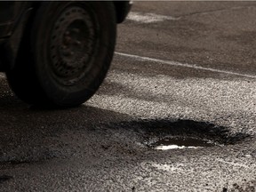 A pothole is seen along 137 Avenue west of 127 Street in Edmonton, on Tuesday, Feb. 23, 2021. Photo by Ian Kucerak