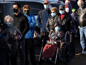 Hundreds of people with vaccination appointments queued outside of an Alberta Health Services clinic at Skyview Power Centre in Edmonton, on Thursday, Feb. 25, 2021. People said that they had waited two hours for a shot. Photo by Ian Kucerak