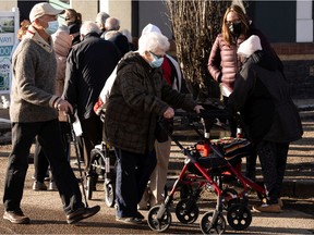 Hundreds of people with vaccination appointments queued outside of an Alberta Health Services clinic at Skyview Power Centre in Edmonton, on Thursday, Feb. 25, 2021. People said that they had waited two hours for a shot. Photo by Ian Kucerak