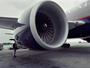 In this file photo an inspector for Pritt and Whitney engines, checks a United Airlines Boeing 777 after it made its inaugural flight from Heathrow Airport in London to Dulles International Airport, in Herndon, Virginia, near Washington on June 7, 1995.