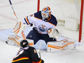 Calgary Flames Mikael Backlund slips one by goalie Mikko Koskinen of the Edmonton Oilers during NHL hockey in Calgary on Saturday February 6, 2021.