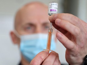 A dose of Oxford-AstraZeneca COVID-19 vaccine is prepared by a member of the Hampshire Fire and Rescue Service at Basingstoke Fire Station, in Basingstoke, Britain Feb. 4, 2021.