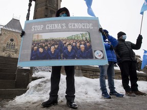 Protesters gather outside the Parliament buildings in Ottawa, Monday, February 22, 2021 ahead of the vote on an opposition motion calling on Canada to recognize China's actions against ethnic Muslim Uighurs as genocide.
