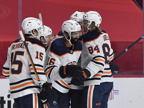 Edmonton Oilers forward Juhjar Khaira (16) reacts with teammates after scoring a goal against the Montreal Canadiens at Bell Centre on Friday, Feb. 12, 2021.