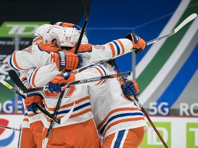 The Edmonton Oilers celebrate forward Connor McDavid's (97) goal against the Vancouver Canucks at Rogers Arena on Tuesday, Feb. 23, 2021.