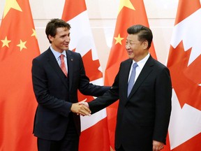 In this Aug. 31, 2016 file photo, Chinese President Xi Jinping shakes hands with Prime Minister Justin Trudeau ahead of their meeting at the Diaoyutai State Guesthouse in Beijing, China.