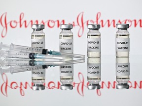 A file photo taken on November 17, 2020 shows vials with Covid-19 Vaccine stickers attached and syringes with the logo of U.S. pharmaceutical company Johnson & Johnson.